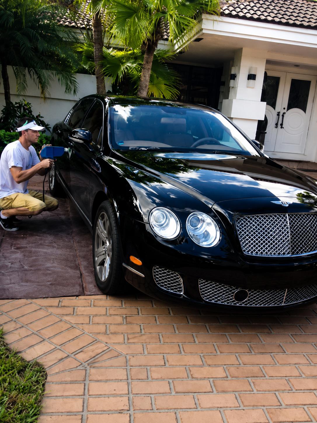 Technician color matching a black Bentley